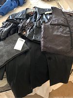 Full lot items displayed including the coat, vest, four pairs of gloves, and wool scarf laid out on a surface.