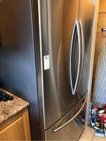 Front view of stainless steel French doors and bottom freezer drawer