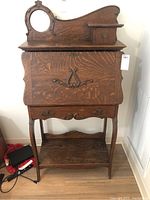Full view of vintage wooden secretary desk with mirror, fold-down writing surface, and drawers