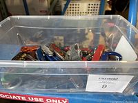Bin view of various pocket cutting tools inside a clear plastic container