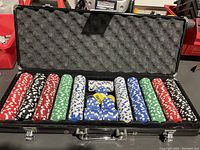 Photo showing the poker chips arranged in the open carrying case. Multiple colors of chips visible in rows.