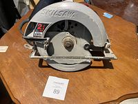 Front side view of the Skil circular saw showing the protective blade guard, motor output label and model number.