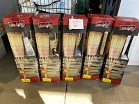 Five boxed solar bamboo torch lights in original packaging, showing the realistic flickering LED light design and bamboo style.