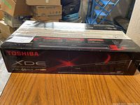 Sealed Toshiba XDE DVD player box showing front with brand and model details.