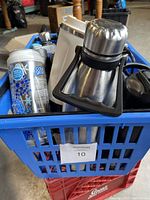 Blue plastic bin filled with various water bottles and travel mugs, showing metal and plastic types with different lid styles.