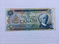 Front of 1972 Canadian five dollar bill with portrait and serial number visible.