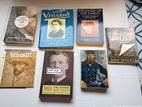 Six Vincent Van Gogh art books shown laid out including biographies and studies with identifiable titles and authors.