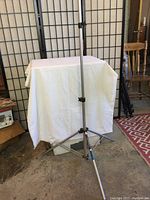 Full view of Manfrotto 36061 tripod partially extended, showing its metal legs and adjustment clamps.