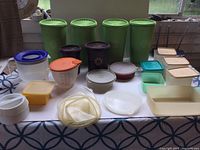 Full view of entire lot with assorted Tupperware containers and lids arranged on table