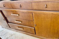 Front view of wooden breakfront showing drawers, cabinet doors, and wood finish.