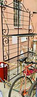Black metal rack/stand with multiple shelves and decorative curved metal details
