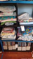 Shelves full of folded children's themed fabrics in assorted prints and colors