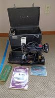 Singer Featherweight 221 sewing machine with carrying case, manuals and accessory box