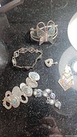 Sterling silver bracelets, pendants including a butterfly pendant and wide cuff bracelet with stones.
