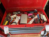 Overview of open top drawer and toolbox contents including wires, clamps, tools, and small accessories