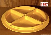 Round yellow acrylic tray with 4 removable quarter-circle sections assembled inside