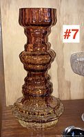 Front view of textured amber glass vase with scalloped clear glass base