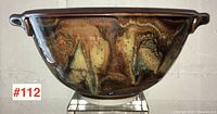 Front view of signed Robin Hopper pottery bowl showing rounded body and color glaze.