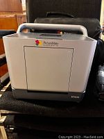 Epson PictureMate personal photo lab photo printer in silver color showing front panel and photo tray.