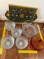 Photo showing full lot including the serving tray, large serving bowl, four smaller bowls, and colored glass candy dish.
