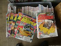 Top view of multiple Street Rodder magazine issues with bright colorful covers focusing on hot rod cars, fanned out.
