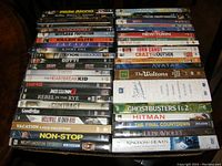 Overview of all DVD movies showing boxed cases stacked in two piles.