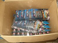 Wide top-down view of an open box containing approximately 50 individual packages of the Hot Wheels Pro Circuit Richard Petty die cast car.