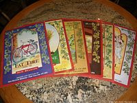 Seven New Belgium beer posters spread on a table, showcasing colorful artwork and text related to different beer types.