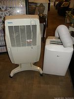 Two portable cooling units side by side on showroom floor