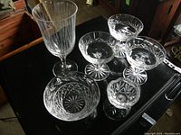 Full lot overview showing 3 sherbert bowls, sugar bowl, bowl, and wine glass arranged on table.