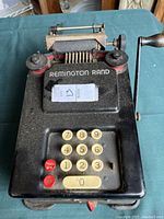 Top view of the adding machine showing keypad and crank handle.