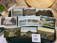 Top view of all 10 postcards laid out, showing front images including landscapes, historical houses, railways, and waterfront scenes