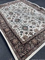 Full view of the large Mohawk Home area rug on floor showing floral pattern and border design.