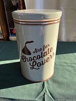 Photo showing front view of ceramic canister with 'Are for Chocolate Lovers' text and Hershey's Kiss image on the side.