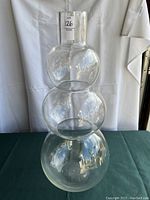 Full front view showing the three large spherical chambers of the continuous blown glass vase.