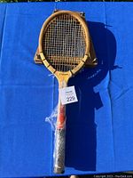 Full view of one Wilson Jack Kramer Valiant wooden tennis racket on blue background with tag 229
