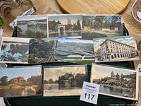 Front sides of ten vintage postcards showing various scenic and architectural images including parks, buildings, rivers, and train scenes.