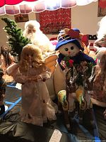 Group view including angel doll, Santa figure, snowman doll, and reindeer figures, showing full arrangement of items