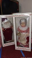 Full view of the Santa Claus and Mrs. Claus animated and illuminated Christmas display figures in original boxes.