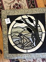 Quilted wall hanging depicting frog in marsh, approximately 24 x 24 inches, showing circular stained-glass-style design with a tree, cattails, and rocks.