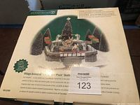 Front of the box showing Department 56 Village Animated Rockefeller Plaza Skating Rink, item number 56.52504