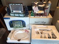 Overview of lot showing two boxed units and styrofoam tray with rink components