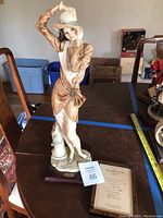 Full view of the Valentina figurine on wooden base with certificate visible