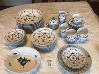Overview of all items: plates stacked by size, bowls, sugar bowl, creamer, teacups and saucers.