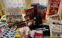 Photo showing full lot including Wheaties boxes, caps, sports cards, baseball, apparel, and printed media