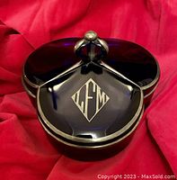 Angled front view showing silver overlay handle, silver trim, and rich cobalt blue glass sections.