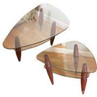 Two triangular-shaped coffee and side tables with polished glass tops and tapered hardwood legs seen from above on a white background.