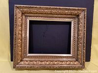 Full view of the ornate gilded frame showing overall dimensions and design