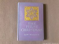 Front cover of the book showing purple cloth binding, gold and silver embossed title and design