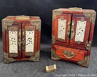 Two wooden Chinese jewelry boxes side by side, showing front view with brass fittings and jade inset panels